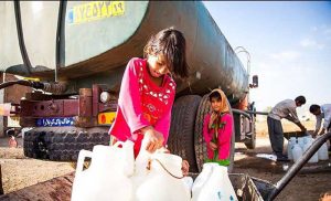 Drought-A girl using water containers to take water home