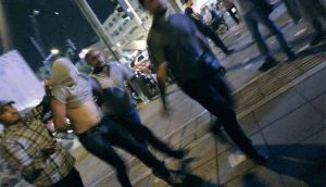 Iranian regime plain cloth forces arrest a young protester in Iran