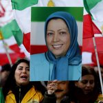 Protester hold's Maryam Rajavi's photo in a rally in London.