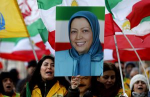 Protester hold's Maryam Rajavi's photo in a rally in London.