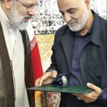 Ebrahim Raisi, the then caretaker of AQR, offers Qassem Soleimani, commander of terrorist Quds Force, the highest honorary title of AQR, July 21, 2018, Mashhad, Iran