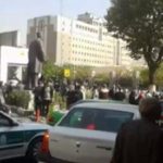 Retirees gather out side the regime's parliament