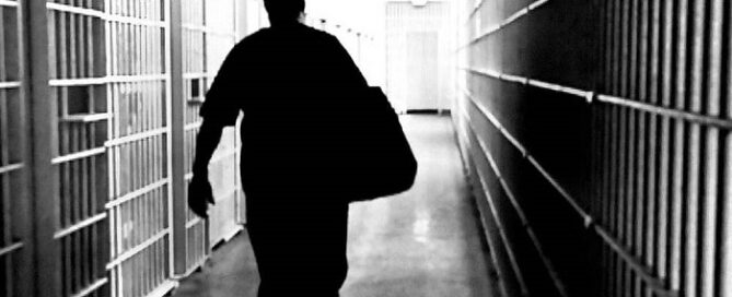 FILE PHOTO: A prisoner walks down a prison corridor